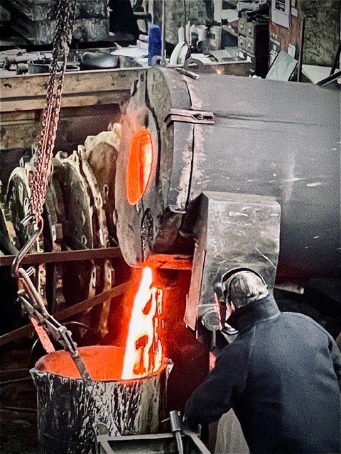 Taylor's Bell Foundry Tour. Molten bell metal being poured in bucket ready for transfer to moulds. 